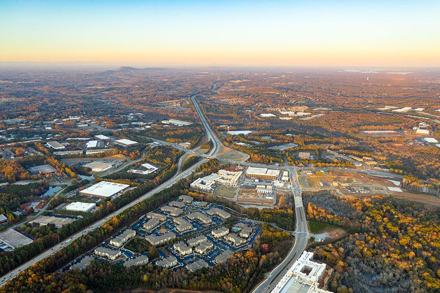 bird's eye view of roads and building roofs in fall at sunset