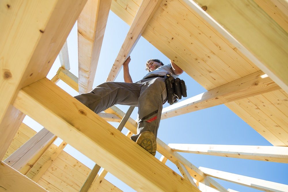 Man Walking on Roof Installation Beams